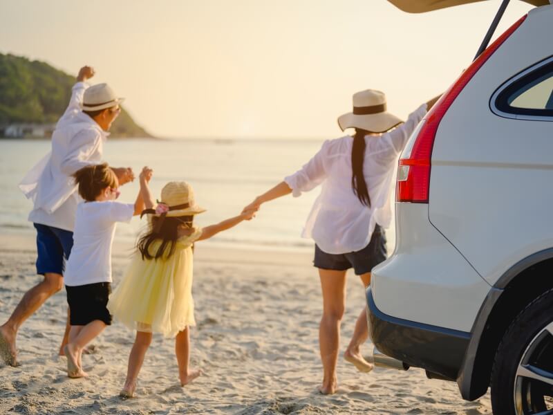 Happy family with rental car